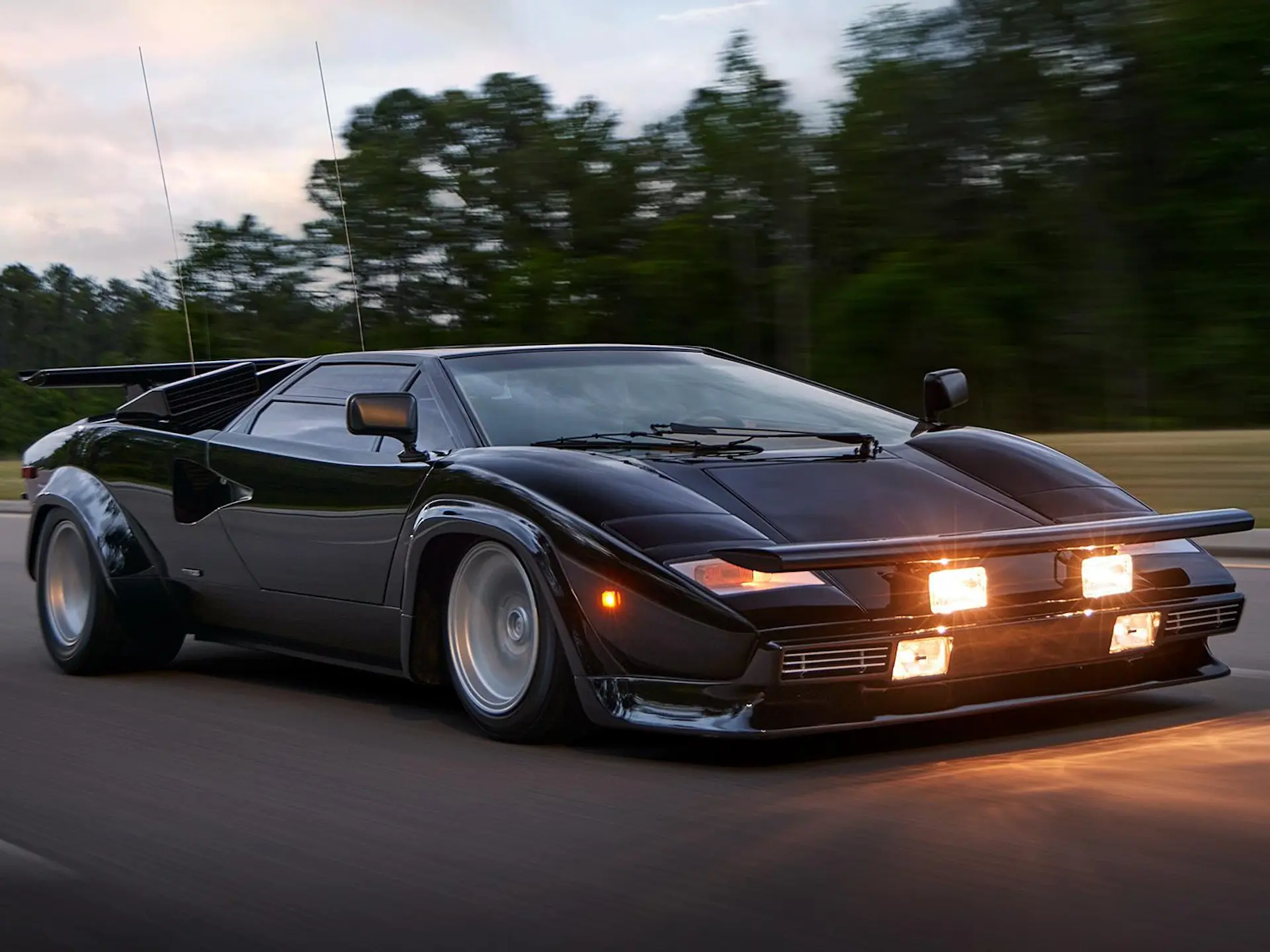 front right pov on road with headlamps on